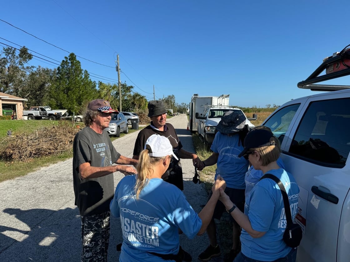 Hope Force Reservists pray with Florida hurricane survivors.